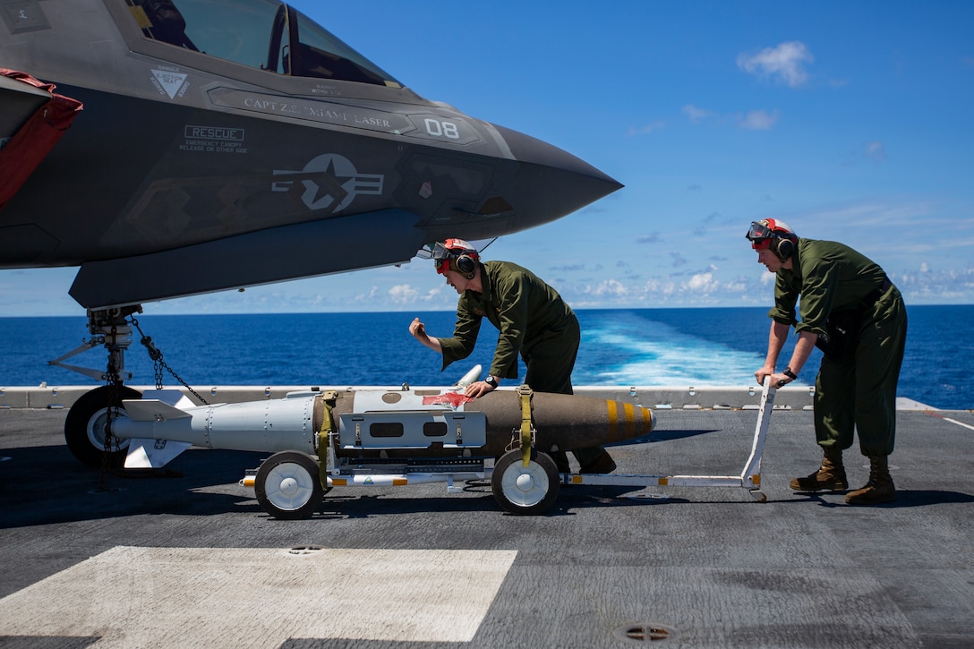 Ordnance Marines with Marine Medium Tiltrotor Squadron 265, 31st Marine Expeditionary Unit, prepare to load a Joint Direct Attack Munition onto an F-35B Lightning II fighter aircraft, aboard the amphibious assault ship USS Wasp, Pacific Ocean, August 7, 2019. Wasp, flagship of the Wasp Amphibious Ready Group, with embarked 31st MEU, is operating in the Indo-Pacific region to enhance interoperability with partners and serve as ready-response force for any type of contingency, while simultaneously providing a flexible and lethal crisis response force ready to perform a wide range of military operations.