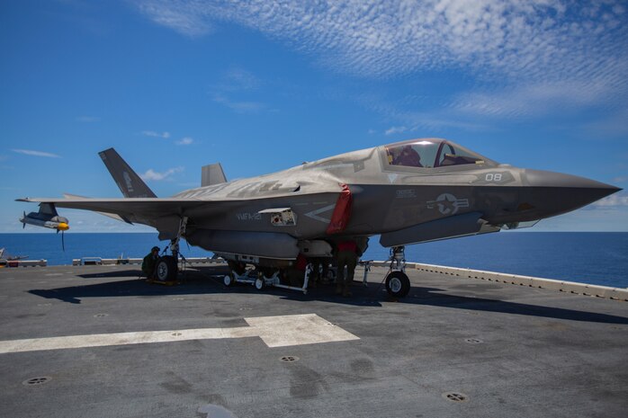 Ordnance Marines with Marine Medium Tiltrotor Squadron 265, 31st Marine Expeditionary Unit, load a Joint Direct Attack Munition onto an F-35B Lightning II fighter aircraft, aboard the amphibious assault ship USS Wasp, Pacific Ocean, August 7, 2019. Wasp, flagship of the Wasp Amphibious Ready Group, with embarked 31st MEU, is operating in the Indo-Pacific region to enhance interoperability with partners and serve as ready-response force for any type of contingency, while simultaneously providing a flexible and lethal crisis response force ready to perform a wide range of military operations.