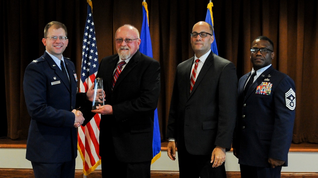 David Fay, National Air and Space Intelligence Center employee, accepts the Maj. Gen. Harold E. Watson Award from Col. Parker H. Wright, NASIC commander, Aug. 2 at the Wright-Patterson Club at Wright-Patterson Air Force Base, Ohio. The Watson award is given to an individual who acts as a selfless champion for NASIC and its people, and is completely dedicated to organizational service.