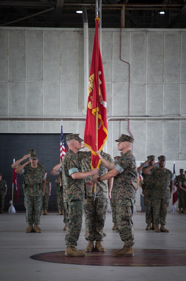 U.S. Marine Corps Col. Todd Ferry passes the Marine Corp Air Station (MCAS) Cherry Point colors to Col. Mikel Huber and relinquishes responsibilities as the commanding officer in an official ceremony at Hangar 131 at MCAS Cherry Point, North Carolina, Aug. 2, 2019. (U.S. Marine Corps photo by Lance Cpl. Michael Neuenhoff)