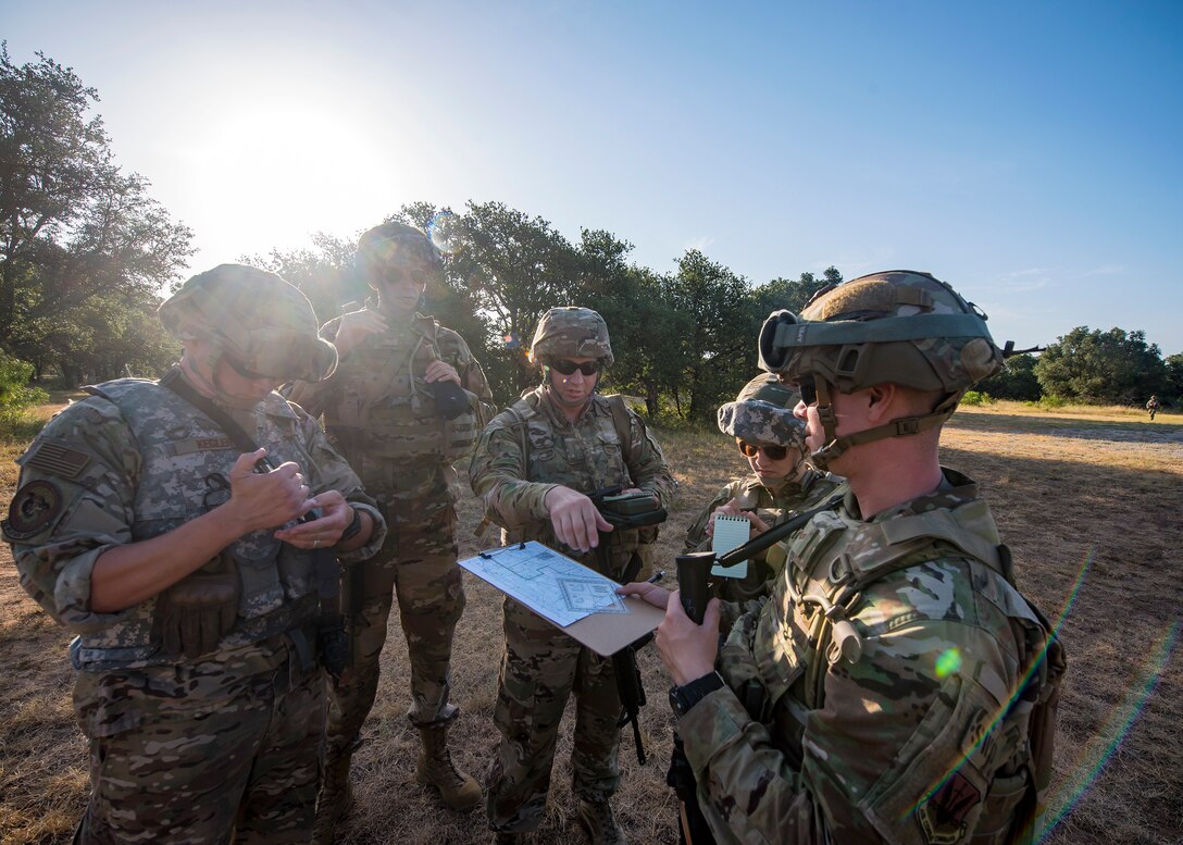 Staff Weather Officers from the 3d Weather Squadron, discuss strategy during a certification field exercise (CFX), July 31, 2019, at Camp Bowie Training Center, Texas. The CFX was designed to evaluate the squadron’s overall tactical ability and readiness to provide the U.S. Army with full spectrum environmental support to the Joint Task Force (JTF) fight. The CFX immersed Airmen into all the aspects of what could come with a deployment such as Land Navigation. (U.S. Air Force photo by Airman 1st Class Eugene Oliver)