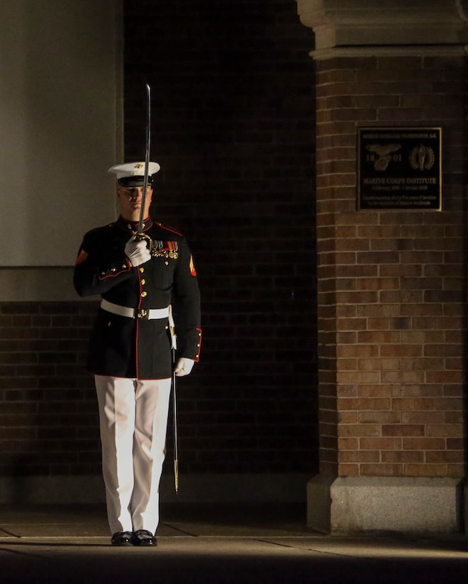 Marines with the noncommissioned officer parade marching staff, Marine Barracks Washington, D.C., march across Center Walk during the Noncommissioned Officer Friday Evening Parade at Marine Barracks Washington, D.C., Aug. 16, 2019. The hosting official for the evening was Lt. Gen. John J. Broadmeadow, director of Marine Corps Staff and the Under Secretary of the Navy, the Honorable Mr. Thomas B. Modly, was the guest of honor. (U.S. Marine Corps photo by Sgt. Robert Knapp/Released)