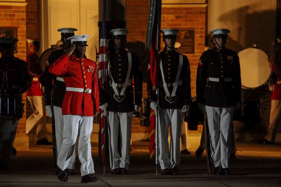 Sergeant Evan Middleton, acting conductor, “The Commandant’s Own” U.S. Marine Drum and Bugle Corps renders a salute during the Noncommissioned Officer Friday Evening Parade at Marine Barracks Washington, D.C., Aug. 16, 2019. The hosting official for the evening was Lt. Gen. John J. Broadmeadow, director of Marine Corps Staff and the Under Secretary of the Navy, the Honorable Mr. Thomas B. Modly, was the guest of honor. (U.S. Marine Corps photo by Sgt. Robert Knapp/Released)