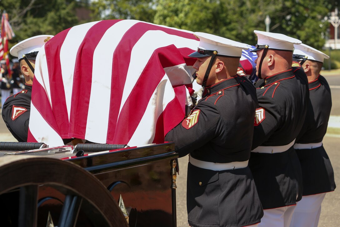 Body Bearers with Bravo Company, Marine Barracks Washington, D.C., put the casket of Maj. Gen. Ronald L. Beckwith on the Caisson during a full honors funeral at Arlington National Cemetery, Arlington, Virginia, Aug. 7, 2019. Beckwith commissioned as a second lieutenant in the Marine Corps in 1957 and served several combat tours in Vietnam as a combat aviator. Beckwith retired from the Marine Corps in 1991 after 34 years of service and passed away on Feb. 19, 2019. (U.S. Marine Corps photo by Pfc Allen Sanders)
