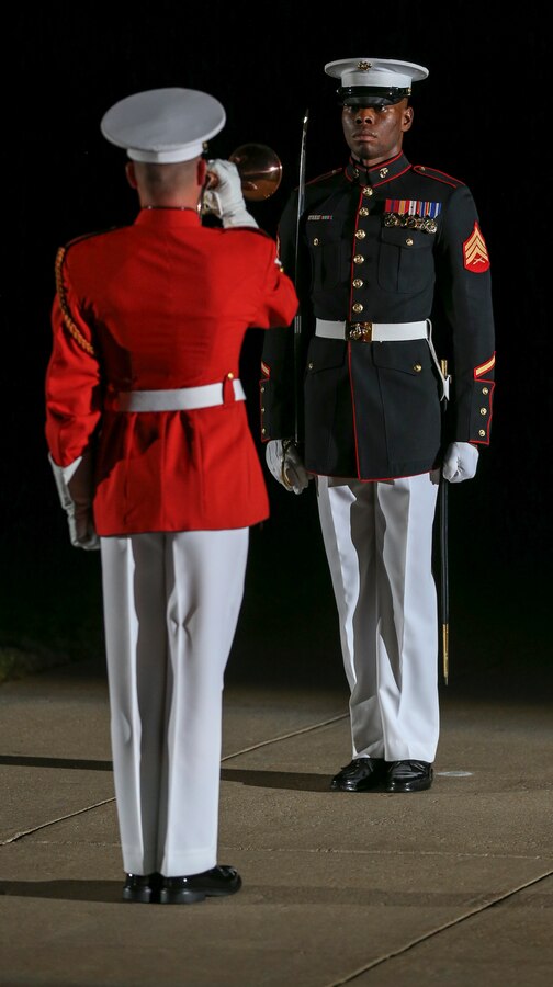 Sergeant Julian Moore, noncommissioned officer parade staff, Marine Barracks Washington, D.C., and Cpl. Teal Ewer, ceremonial bugler, “The Commandant’s Own” U.S. Marine Drum and Bugle Corps, perform during the Noncommissioned Officer Friday Evening Parade at Marine Barracks Washington, D.C., Aug. 16, 2019. The hosting official for the evening was Lt. Gen. John J. Broadmeadow, director of Marine Corps Staff and the Under Secretary of the Navy, the Honorable Mr. Thomas B. Modly, was the guest of honor.  (U.S. Marine Corps photo by Pfc. Allen Sanders)