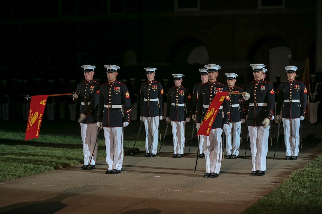 Marines with Marine Barracks Washington, D.C., stand at attention for the “officers center” sequence during the Noncommissioned Officer Friday Evening Parade at Marine Barracks Washington, D.C., Aug. 16, 2019. The hosting official for the evening was Lt. Gen. John J. Broadmeadow, director of Marine Corps Staff and the Under Secretary of the Navy, the Honorable Mr. Thomas B. Modly, was the guest of honor. (U.S. Marine Corps photo by Pfc. Allen Sanders)