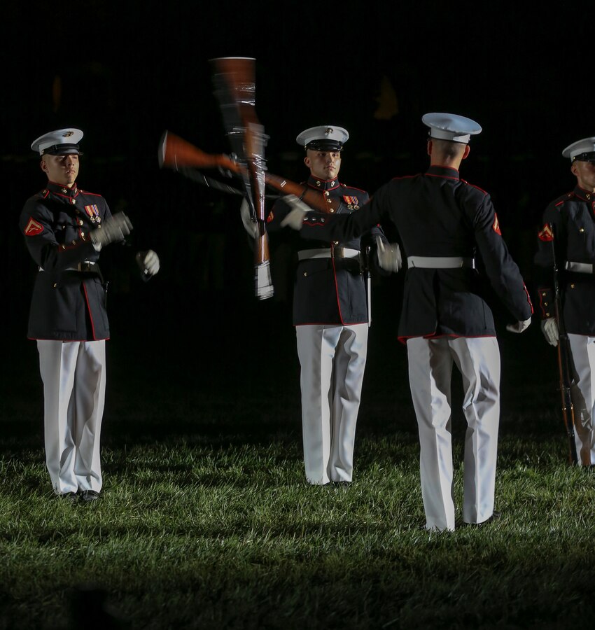 Marines with the U.S. Marine Corps Silent Drill Platoon execute their “long line” sequence during the Noncommissioned Officer Friday Evening Parade at Marine Barracks Washington, D.C., Aug. 16, 2019. The hosting official for the evening was Lt. Gen. John J. Broadmeadow, director of Marine Corps Staff and the Under Secretary of the Navy, the Honorable Mr. Thomas B. Modly, was the guest of honor. (U.S. Marine Corps photo by Pfc. Allen Sanders)