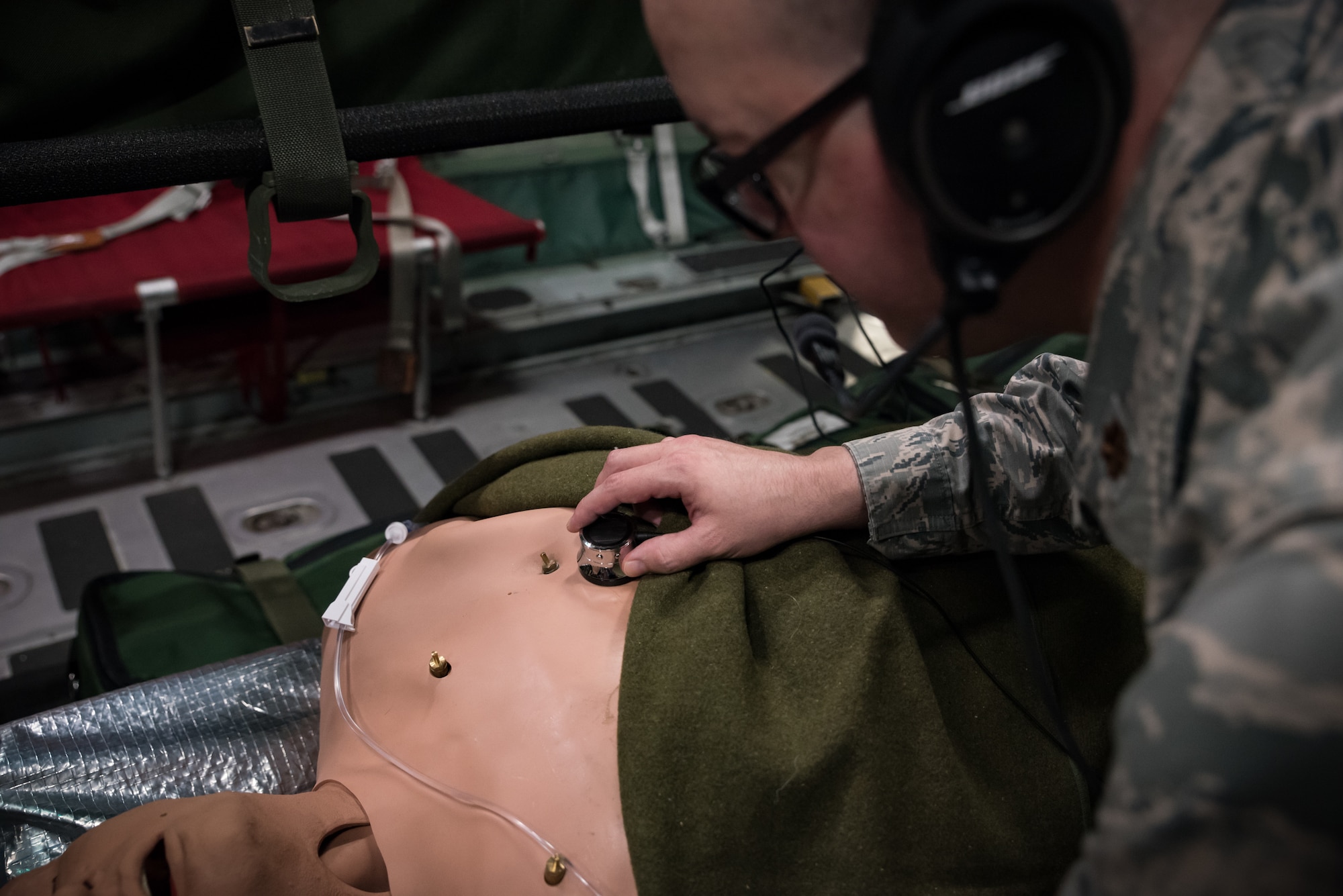 While testing the new wireless high-noise filtering stethoscope, Maj. Daniel Bevington, a nurse researcher in the 711th Human Performance Wing of the Air Force Research Laboratory, places the device on a mannequin’s chest to listen to internal sounds. (U.S. Air Force photo/Richard Eldridge)