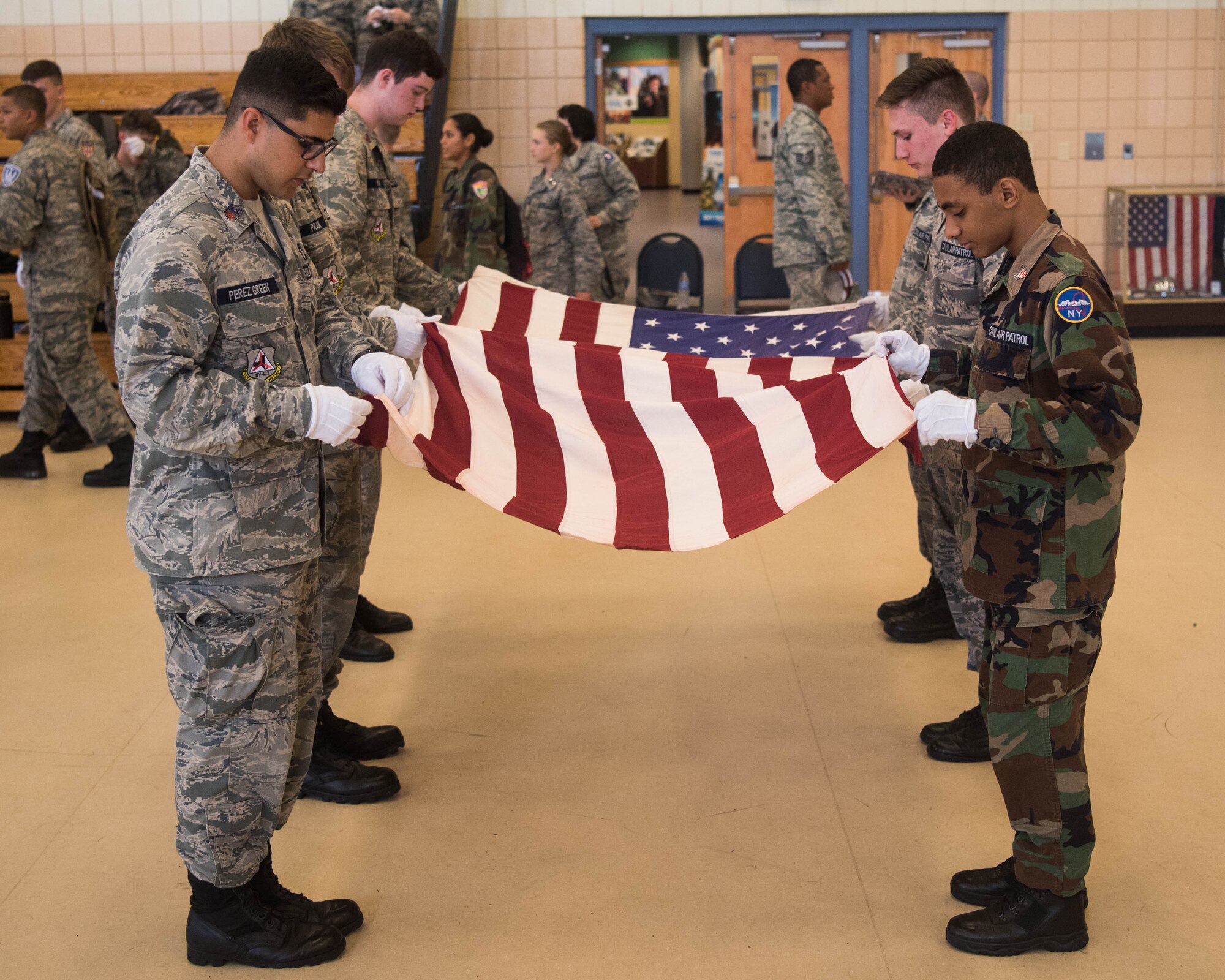 Members of the Civil Air Patrol fold the U.S. Flag at Joint Base Langley-Eustis, Virginia, July 17, 2019. CAP has 52 wings which includes every state plus the National-Capitol Wing of Washington, D.C., and the Puerto Rico Wing. (U.S. Air Force photo by Airman 1st Class Marcus M. Bullock)