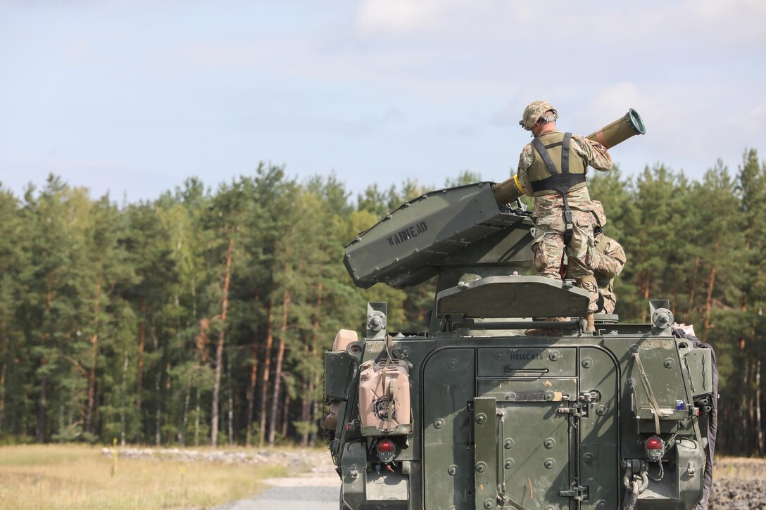 Man works on vehicle-mounted missile.