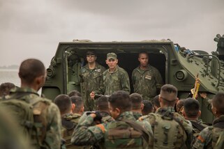 A military leader gives a safety brief to a group of troops.