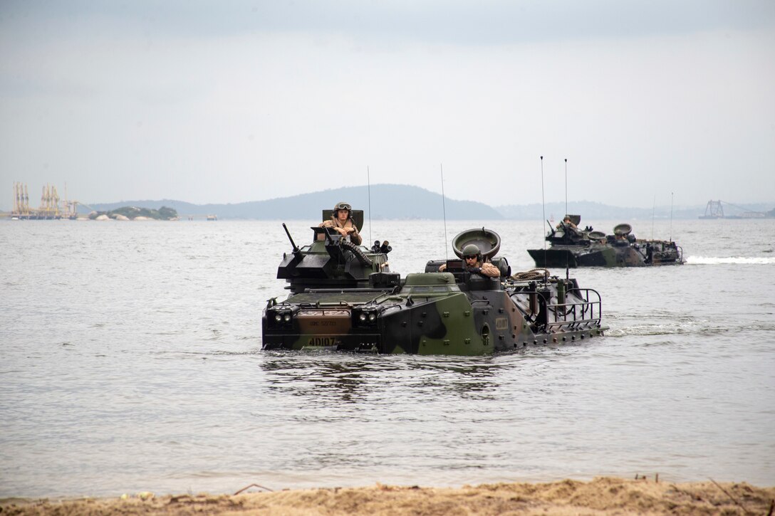 Marine amphibious assault vehicles in the water.