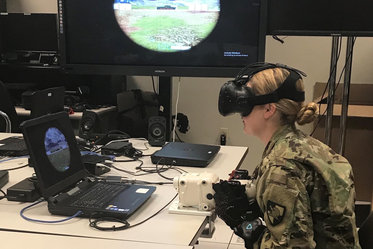Woman looks through viewing device.