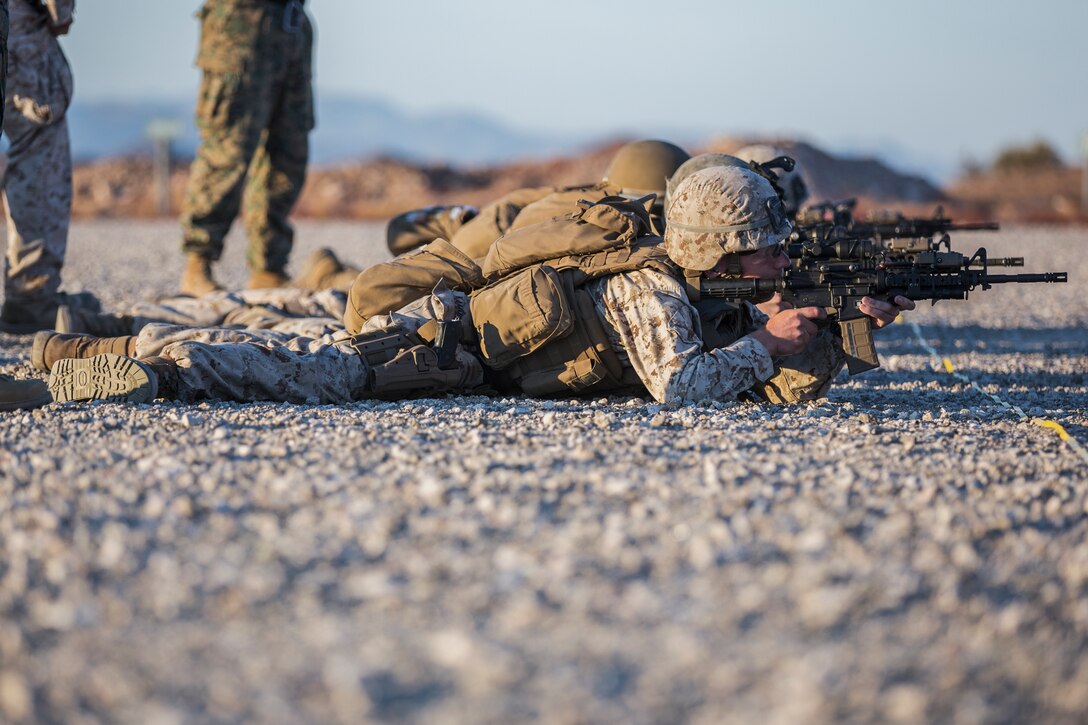 U.S. Marines currently assigned to the Military Working Dog (MWD) Team Deployment Training Course conduct their live fire training exercise with their MWD's on the Graze Range at Yuma Proving Ground (YPG), August 16, 2019. The exercise consists of familiarization and exposing the MWD's to gunfire and a series of drills where handlers proficiently engage targets while maintaining positive control of their MWD's. (U.S. Marine Corps photo by Cpl. Sabrina Candiaflores)