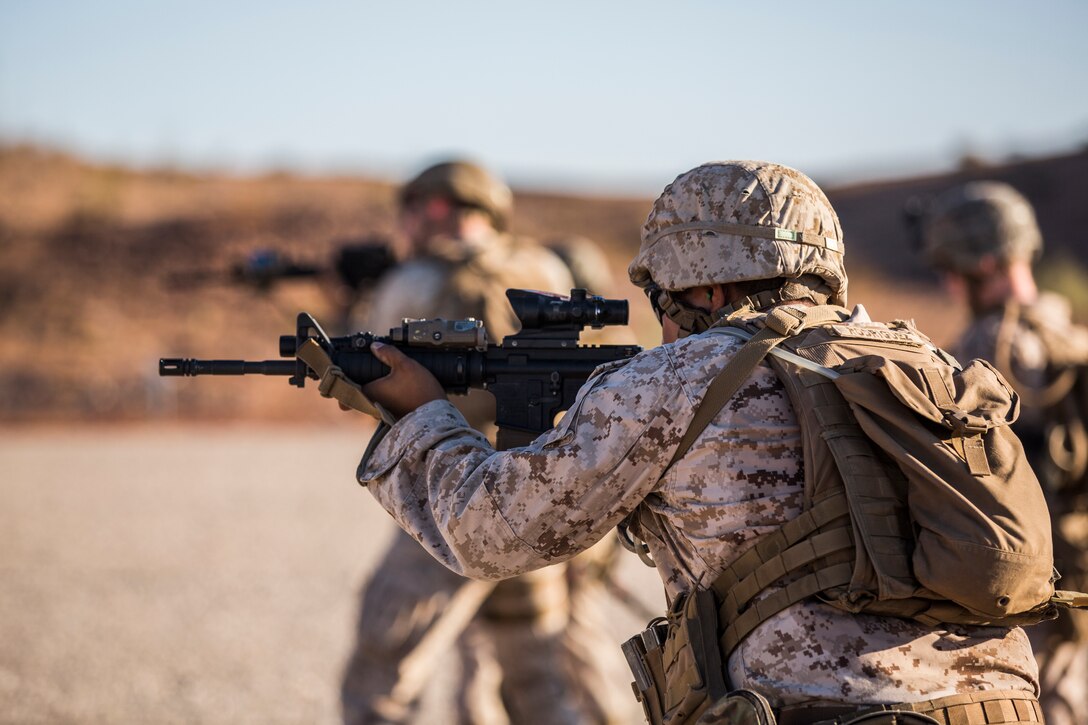 U.S. Marines currently assigned to the Military Working Dog (MWD) Team Deployment Training Course conduct their live fire training exercise with their MWD's on the Graze Range at Yuma Proving Ground (YPG), August 16, 2019. The exercise consists of familiarization and exposing the MWD's to gunfire and a series of drills where handlers proficiently engage targets while maintaining positive control of their MWD's. (U.S. Marine Corps photo by Cpl. Sabrina Candiaflores)