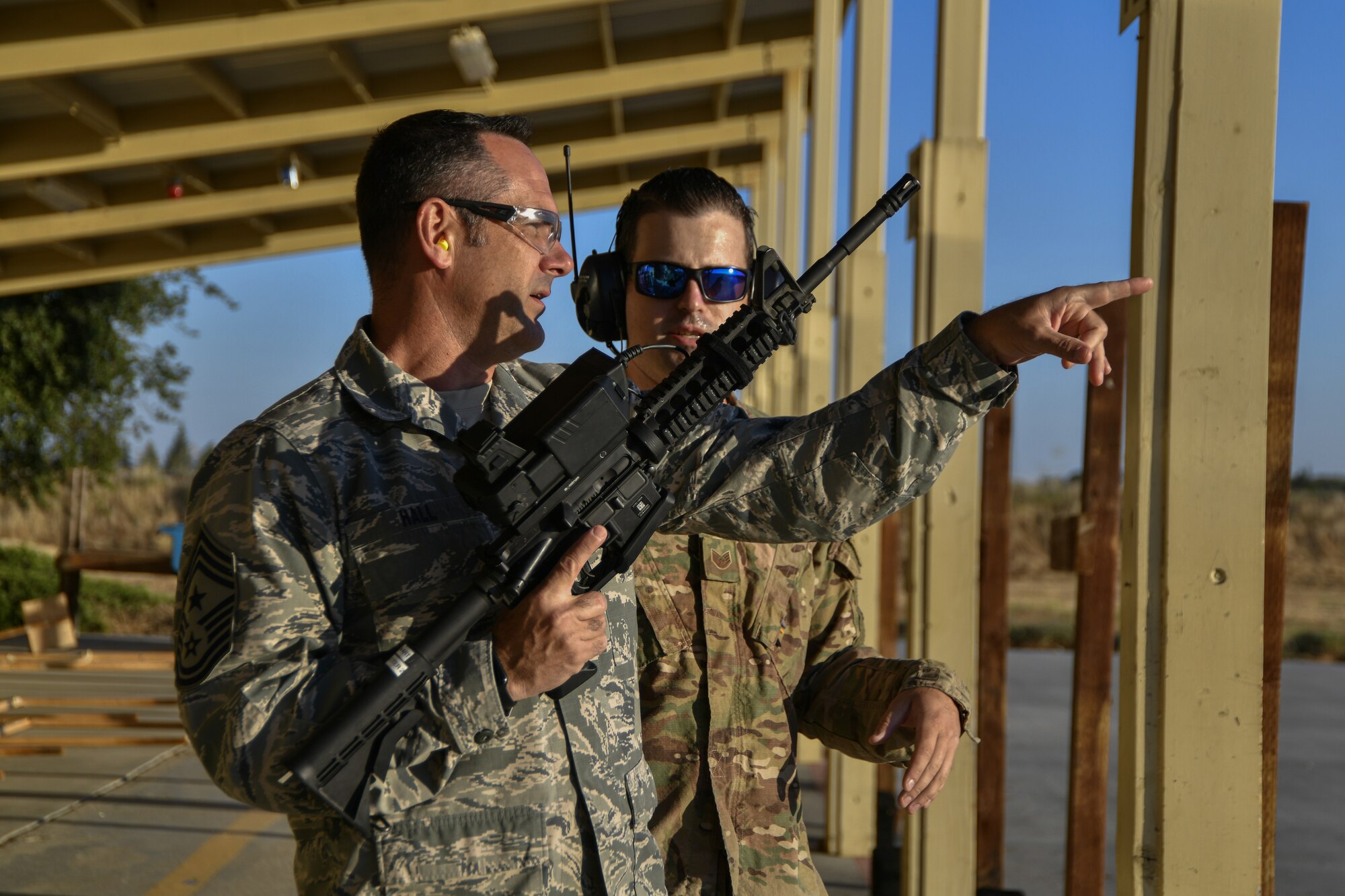 Chief Master Sgt. Dustin Hall, 9th Reconnaissance Wing command chief, receives instruction on how to use the Smart Shooter sighting device from Staff Sgt. Colton Becker, 9th Security Forces Squadron training flight, during a demonstration at Beale Air Force Base, California, Aug. 14, 2019. The 9th SFS Airmen have been using off the shelf commercial technology to help train and improve how their missions are conducted to protect the installation and the Beale AFB mission. (U.S. Air Force photo by Tech. Sgt. Alexandre Montes)