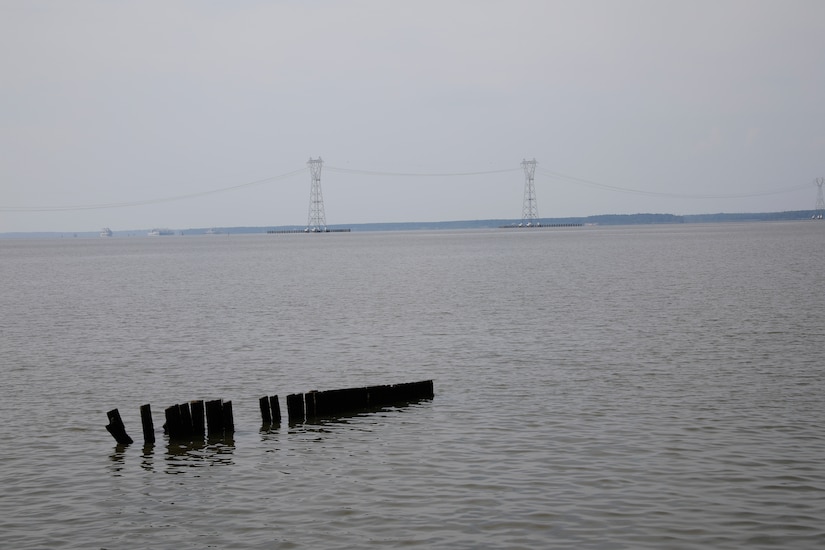 This image was taken along the shoreline at 37,11'58.24"N 76,37'26.03"W, which is on the Carters Grove Plantation property. A 75mm focal length was used as this best matched up the size of the towers  through the viewfinder on a full frame camera with what the human eye was seeing at the location.