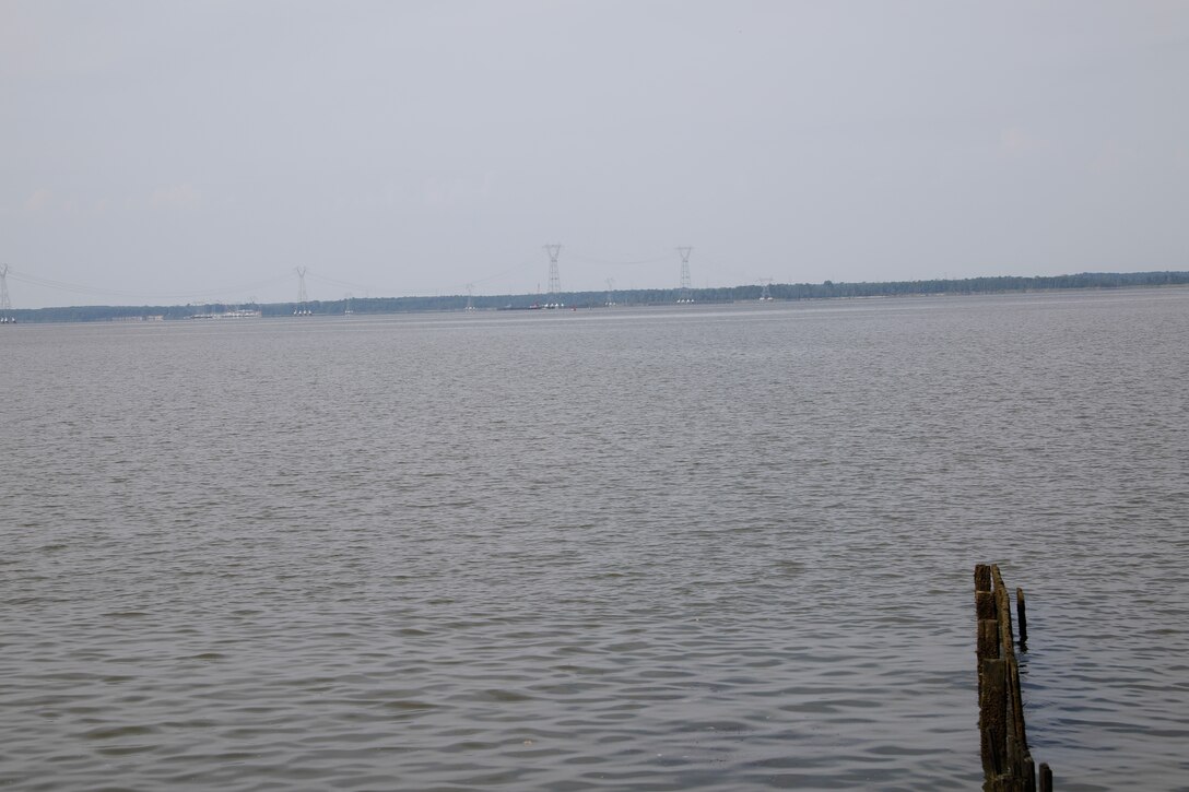 This image was taken along the shoreline at 37,11'58.24"N 76,37'26.03"W, which is on the Carters Grove Plantation property. A 75mm focal length was used as this best matched up the size of the towers  through the viewfinder on a full frame camera with what the human eye was seeing at the location.