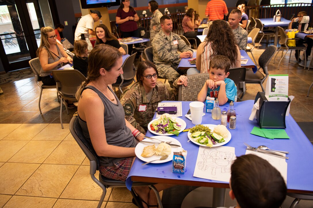 Participants converse during a Deployed Spouse’s Dinner, Aug. 20, 2019, at Moody Air Force Base, Ga. The dinner served as an opportunity for the families of deployed members to bond and provide relief. The mission’s success depends on resilient Airmen and families, who are prepared to make sacrifices with the support of their fellow Airmen, local communities and leadership. (U.S. Air Force photo by Airman Elijah M. Dority)