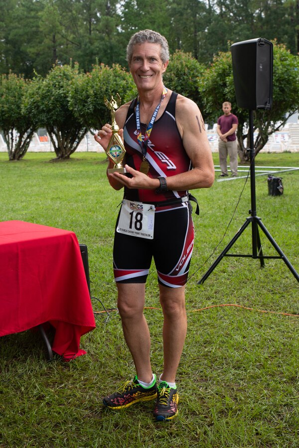 Ricky Davis poses for a photo during the Marine Corps Community Services’ 20th Annual Sprint Triathlon at Marine Corps Air Station Cherry Point, North Carolina, Aug. 17, 2019. Davis won first place in the men’s 60 and above age group. This is about his fourth time attending the event. (U.S. Marine Corps photo by Lance Cpl. Alexandra Santos Arambulo)