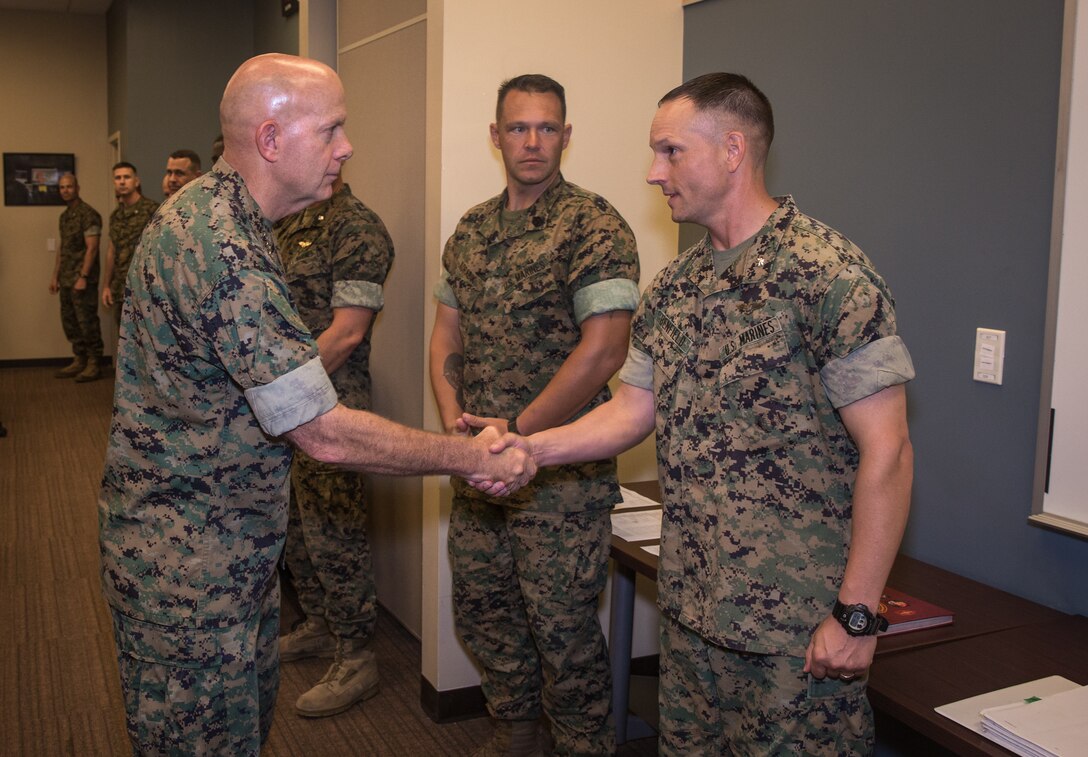 U.S. Marine Corps Commandant Gen. David Berger greets Lt. Col. Christopher Benfield, commanding officer of Headquarters and Headquarters Squadron with a hand shake at Marine Corps Air Station (MCAS) Cherry Point, before sitting for a discussion with installation leaders in the Battle Lab at Marine Air Support Squadron 1, July 31, 2019. Berger and Sgt. Maj. of the Marine Corps Troy Black sat down with leaders to discuss various issues and topics about the welfare and future of the air station. (U.S. Marine Corps photo by Cpl. Micha Pierce)
