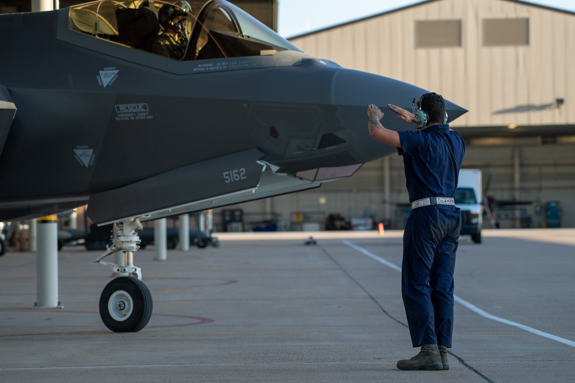 A crew chief with the 388th Fighter Wing marshals an F-35A prior to take off from Hill Air Force Base, Utah, the evening of Aug. 20, 2019, as the active duty 388th and reserve 419th Fighter Wings conducted local night flying operations. The wings are required to train at night to maintain their readiness and all-weather capabilities. Increased flying also provides a valuable opportunity to evaluate aircraft maintenance resiliency and operational agility. (U.S. Air Force photo by R. Nial Bradshaw)