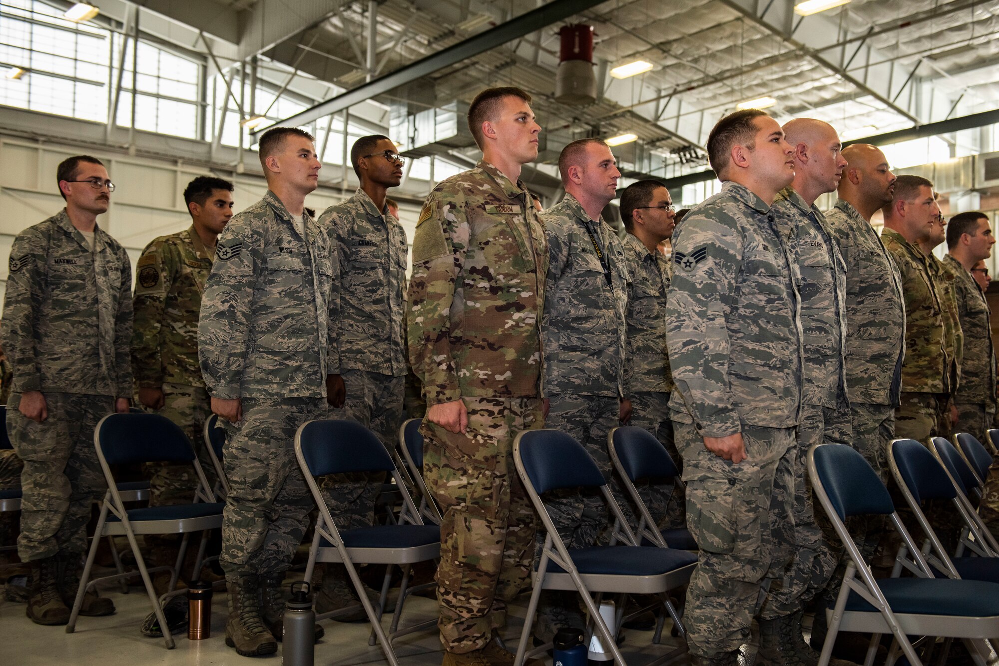 Tactical aircraft maintainers assigned to the 57th Maintenance Group are inducted as Dedicated Crew Chiefs at Nellis Air Force Base, Nevada, Aug. 16, 2019. Thirty-four Airmen were selected and assigned to an aircraft by their section supervision. (U.S. Air Force photo by Senior Airman Miranda A. Loera)