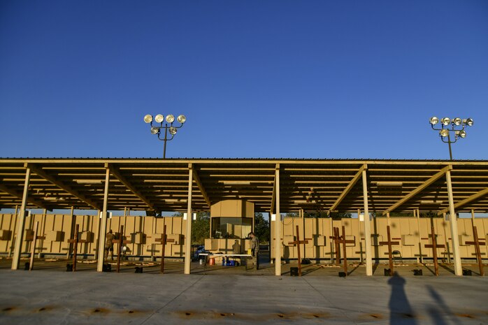 Staff Sgt. Colton Becker, 9th Security Forces Squadron training flight, and Senior Airman Matthew Gurich, 9th SFS training flight, prepare the firing range prior to a demonstration of the Smart Shooter sighting device at Beale Air Force Base, California, Aug. 14, 2019. The sighting device attaches to the weapon and locks on then fires to neutralize its target with or without movement. The device is also being used to limit friendly fire as the weapon cannot be fired unless it is purposely locked on. (U.S. Air Force photo by Tech. Sgt. Alexandre Montes)