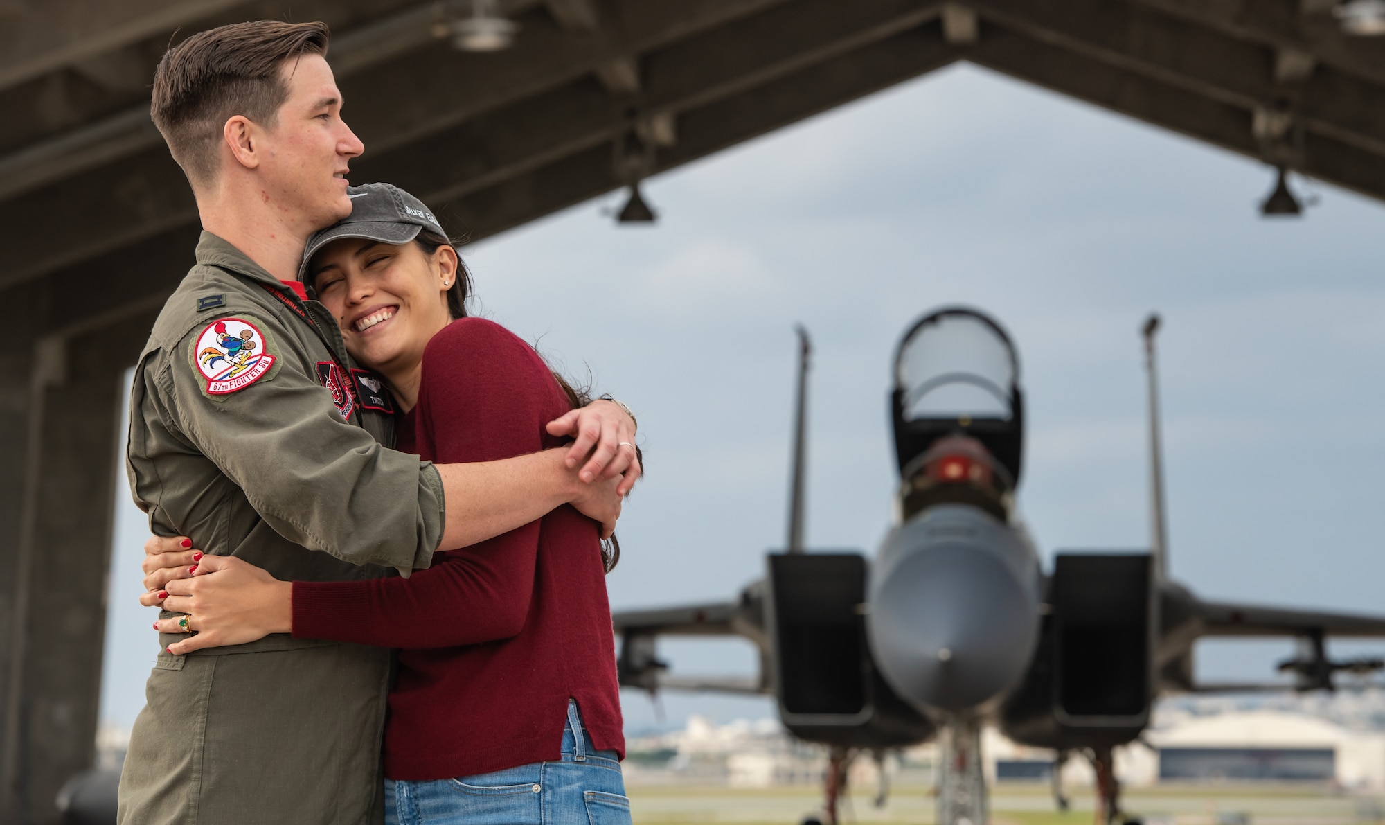U.S. Air Force Capt. Cole Holloway a pilot from the 67th Fighter Squadron, hugs his wife, Meghan Holloway, Dec. 14, 2018, on Kadena Air Base, Japan.