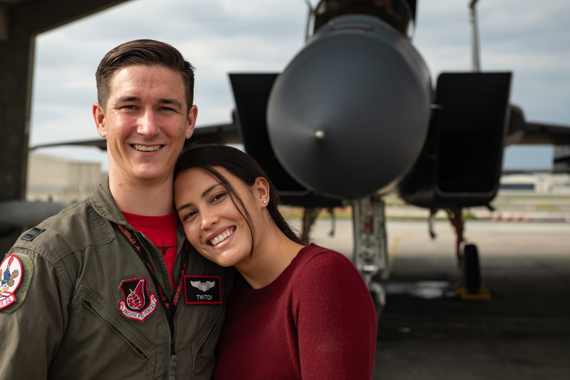 U.S. Air Force Capt. Cole Holloway a pilot from the 67th Fighter Squadron, and his wife, Meghan Holloway, stand in front of an F-15C Eagle Dec. 14, 2018, on Kadena Air Base, Japan.