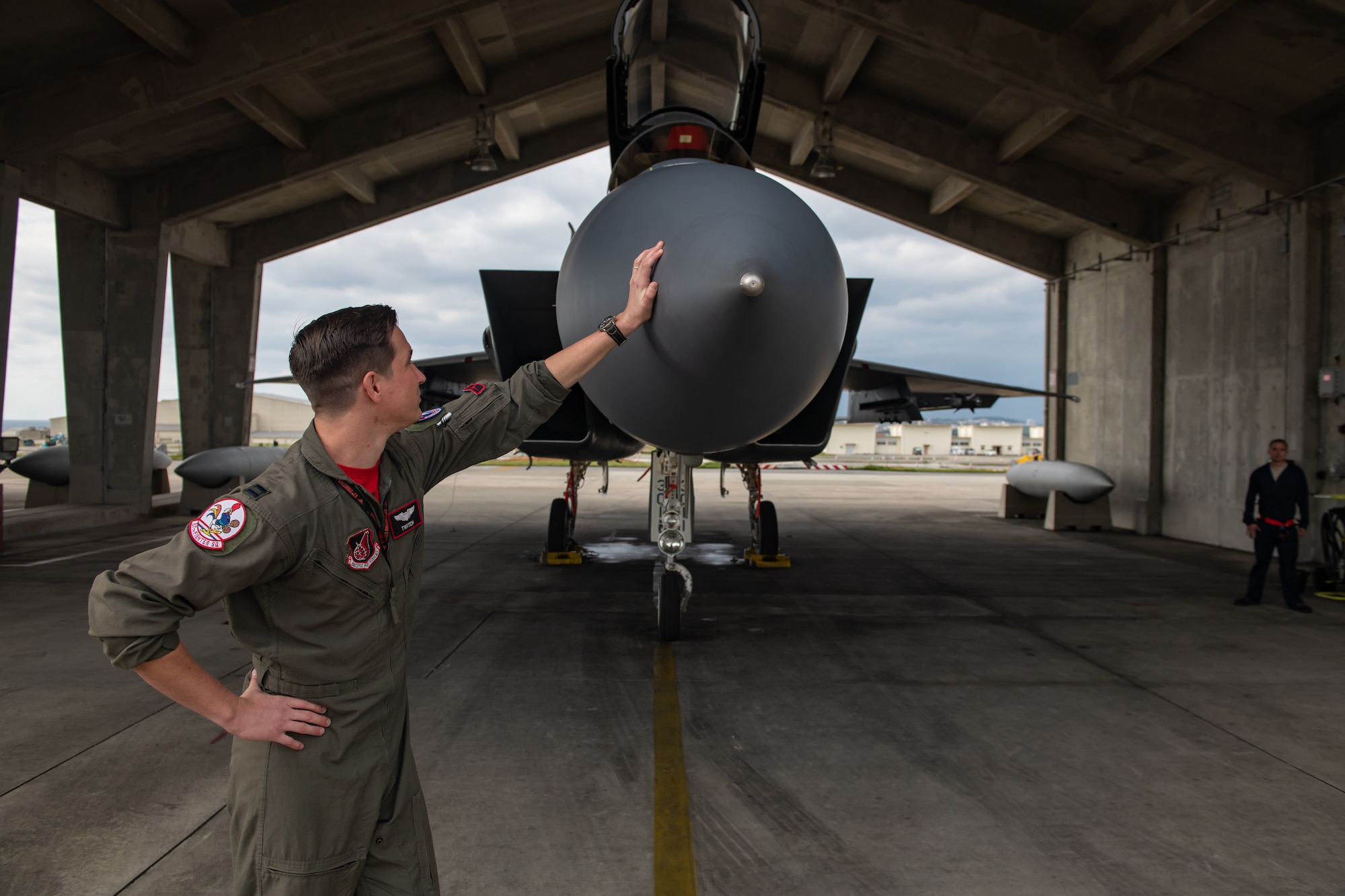 U.S. Air Force Capt. Cole Holloway a pilot from the 67th Fighter Squadron, looks at an F-15C Eagle Dec. 14, 2018, on Kadena Air Base, Japan.