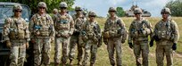 Observer Controller Trainers assigned to the Joint Multinational Readiness Center (JMRC) pose for a picture during a Combined Resolve training exercise in Grafenwoehr Training Area, August, 8, 2019.