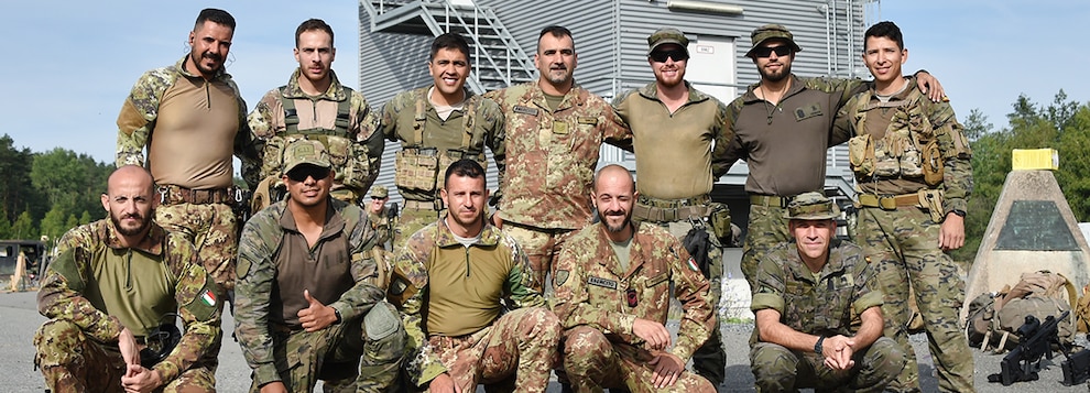 Sniper teams from Italy and Spain get together for a group photo before the start of the stress shoot event during the European Best Sniper Team Competition at Grafenwoehr, Germany, July 22, 2019.