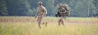 An Italian sniper runs with a U.S. Soldier assigned to the 173rd Airborne Brigade during the stress shoot event of the European Best Sniper Team Competition at Grafenwoehr, Germany, July 22, 2019.