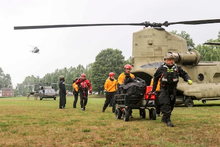 Pennsylvania National Guard members joined with partners in the Helicopter Aquatic Rescue Team (PA-HART) and other civilian first responders in a full-scale exercise at Fort Hunter Park and the Susquehanna River Aug. 15, 2019. A Ch-47 Chinook helicopter unloads a boat team at Fort Hunter Park while UH-60 Black Hawk helicopters land with members of the 28th Expeditionary Combat Aviation Brigade.