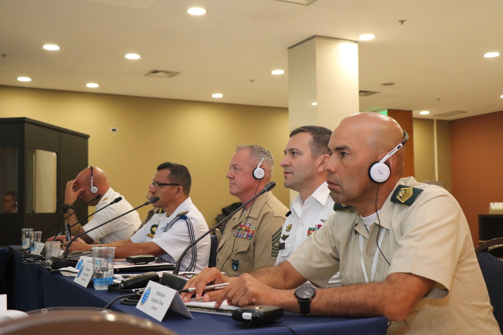 Military leaders speak at a conference.