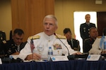 Military leaders speak at a conference.