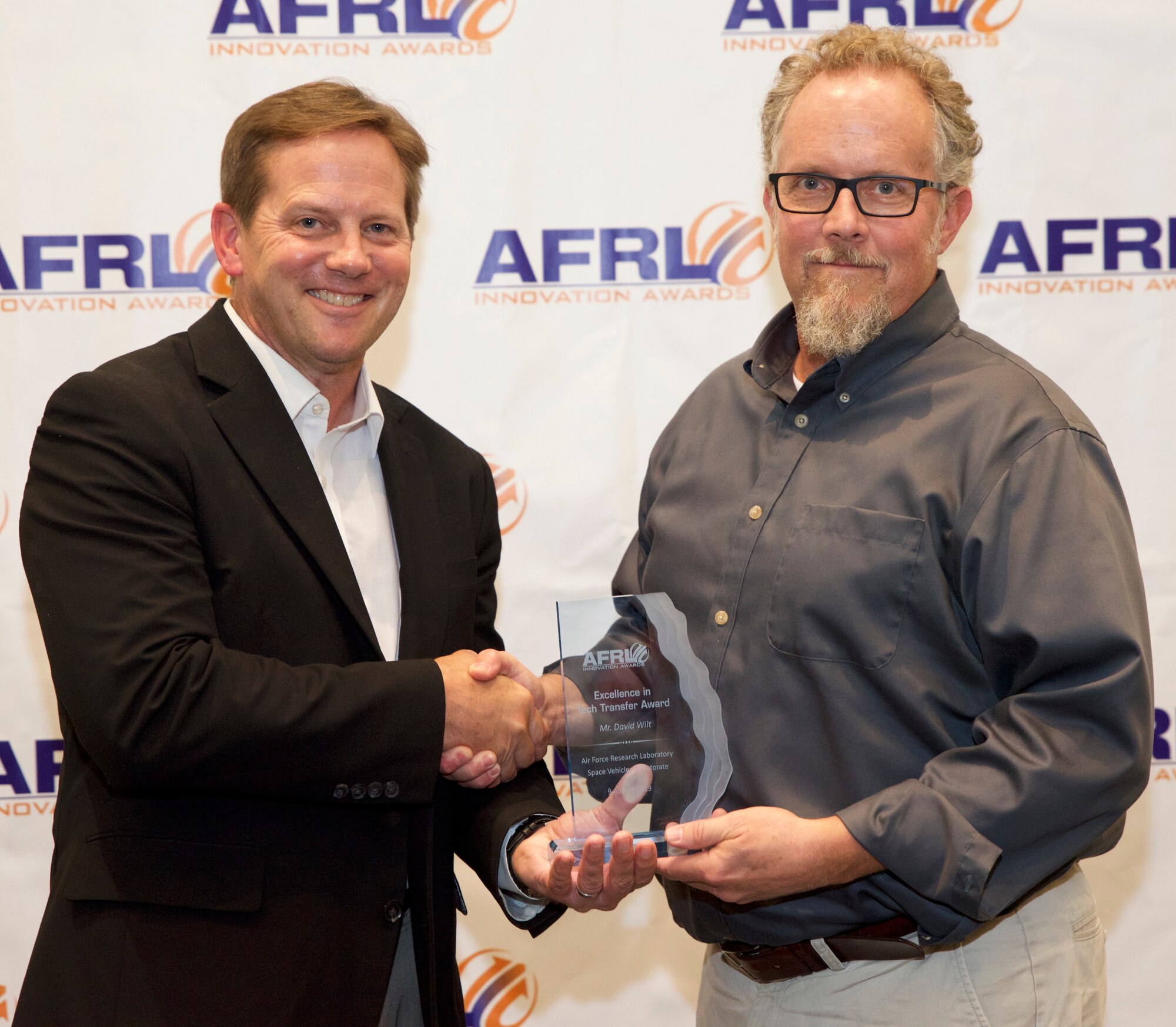 Dr. Kelly Hammett director of the AFRL Directed Energy Directorate presents David Wilt of AFRL’s Space Vehicles Directorate the Excellence in Tech Transfer Award at AFRL New Mexico’s 2019 Innovation Awards event held on Aug. 9 in Albuquerque, N.M.