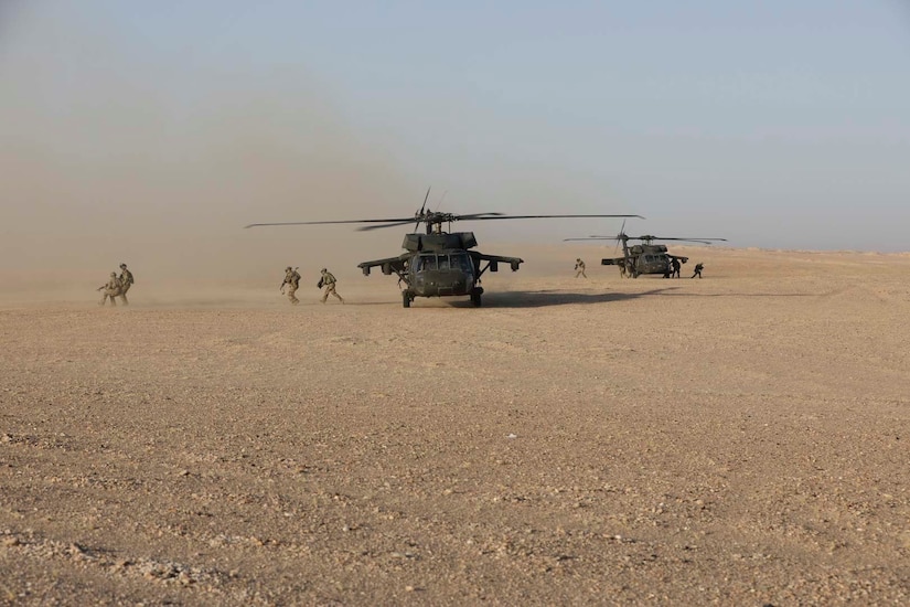 Soldiers of the 3rd Armor Brigade Combat Team, 4th Infantry Division, air assault out of UH-60 Blackhawk helicopters piloted by Soldiers of the 8th Assault Helicopter Battalion, 229th Aviation Regiment, at Udairi Range Complex near Camp Buehring, Kuwait, July 24, 2019. The 8-229th AHB “Flying Tigers” currently supports U.S. Army Central’s Operation Spartan Shield as Task Force Javelin and takes advantage of every opportunity to train with ground force units.