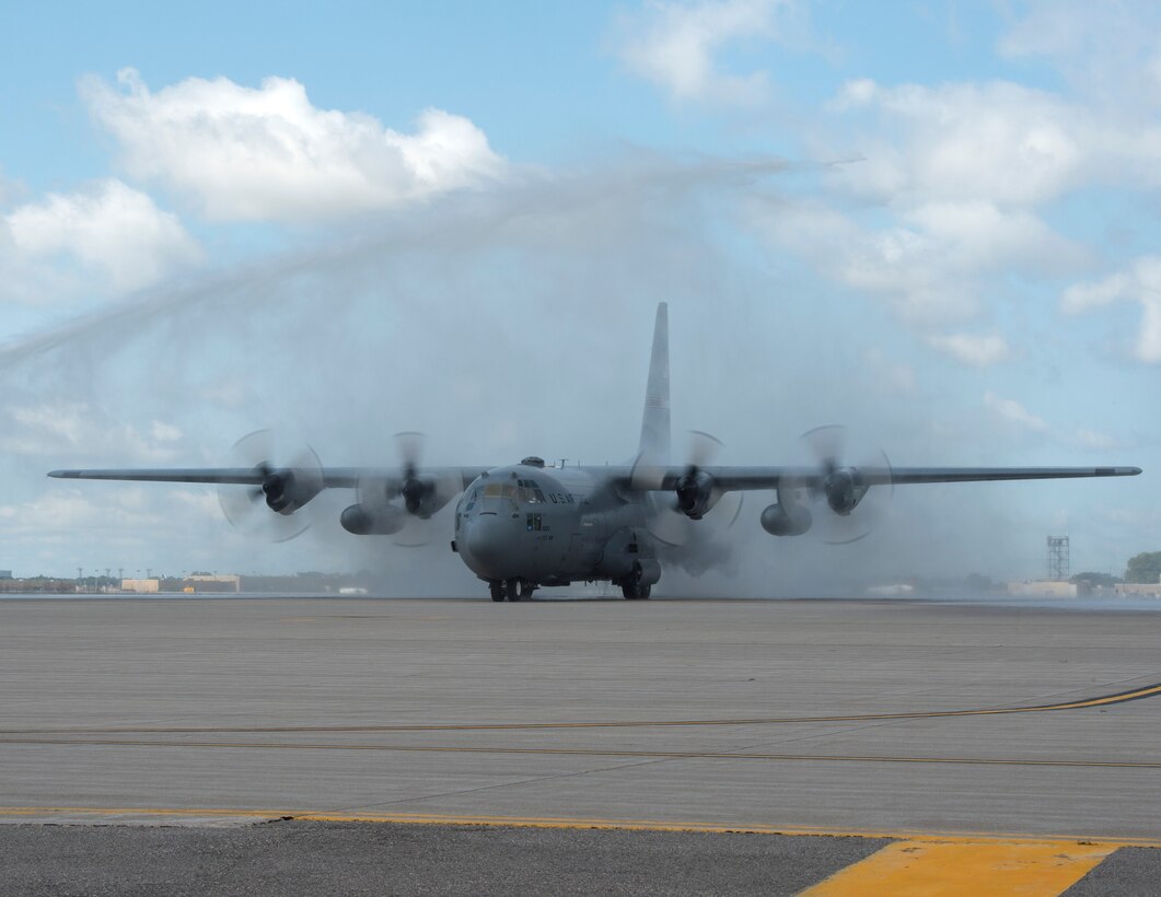 Fire engines from the Metropolitan Airport Commission give U.S. Air Force Col. Daniel Gabrielli, 133rd Airlift Wing commander, a water salute after he completes his fini-flight in St. Paul, Minn., Aug. 16, 2019.