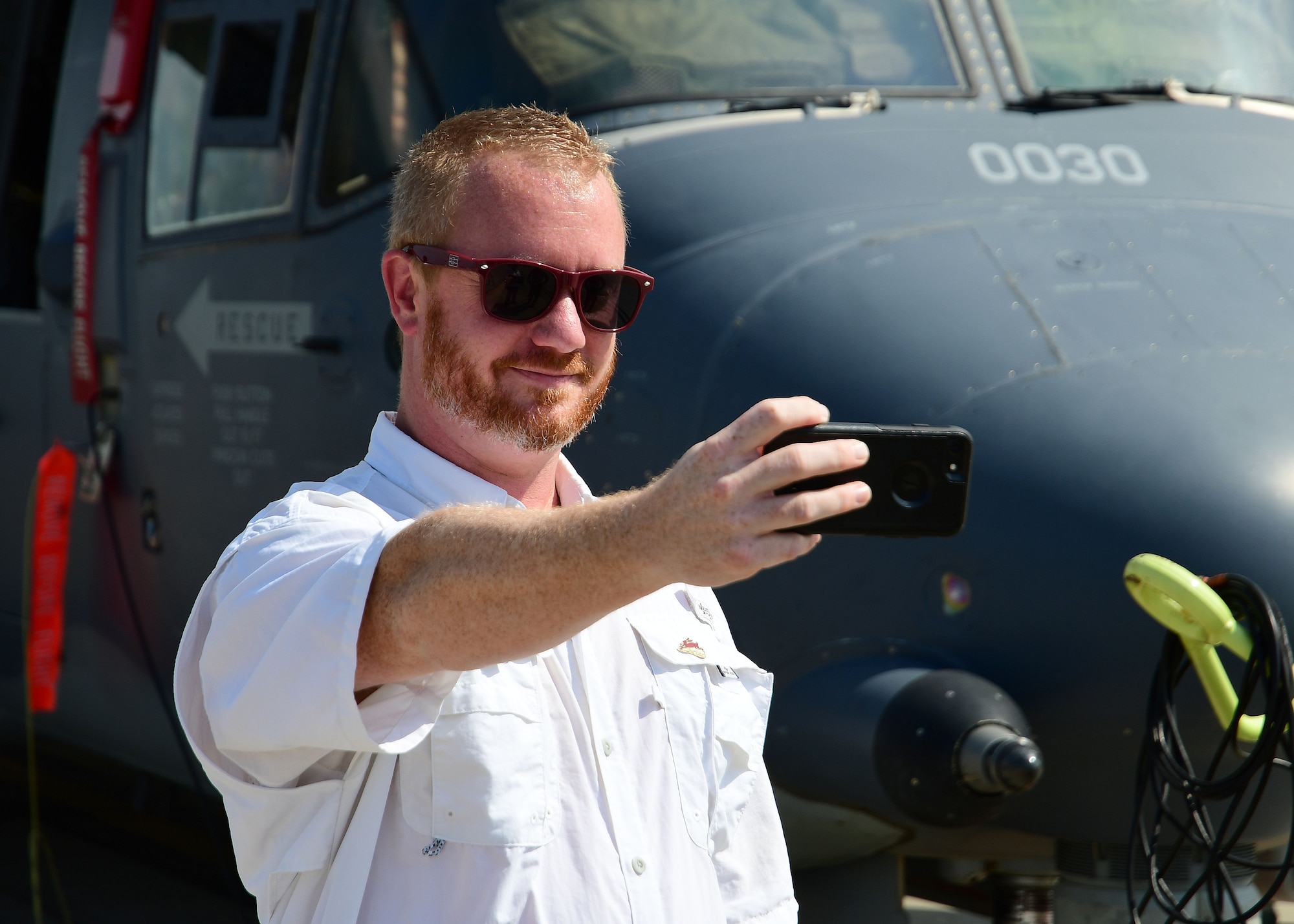 A metro Atlanta civic leader takes a selfie in front of a CV-22 Osprey at Hurlburt Field, Florida, Aug. 14, 2019.