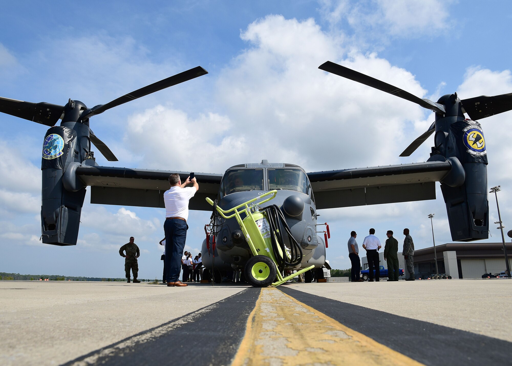 A metro Atlanta civic leader takes a photo of a CV-22 Osprey at Hurlburt Field, Florida, Aug. 14, 2019.