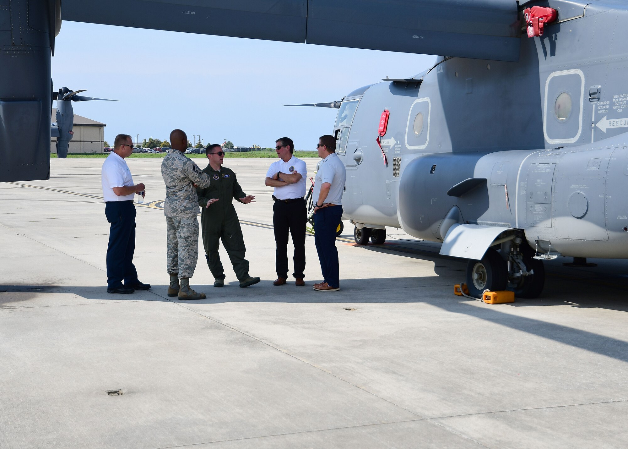 Lt. Col. Richard Konopczynski, 700th Airlift Squadron, right, and Senior Master Sgt. Thomas Metcalf, 94th Security Forces Squadron, talk with a group of civic leaders during a tour of the flightline at Hurlburt Field, Florida, Aug. 14, 2019.