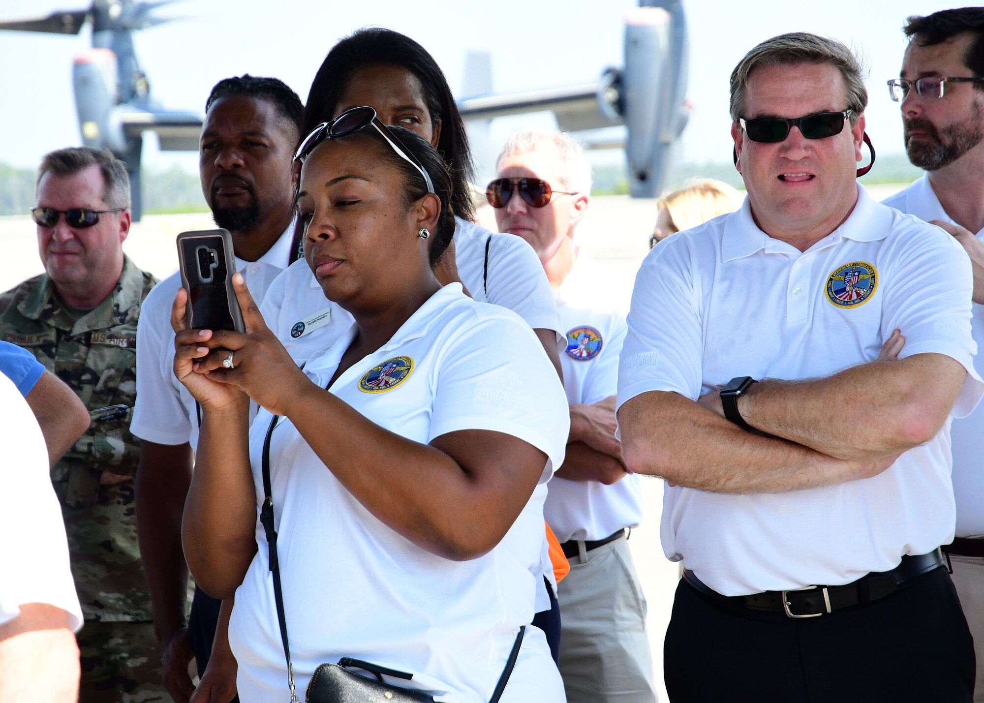 A metro Atlanta civic leader takes photos of a CV-22 Osprey during a static aircraft display at Hurlburt Field, Florida, Aug. 14, 2019.