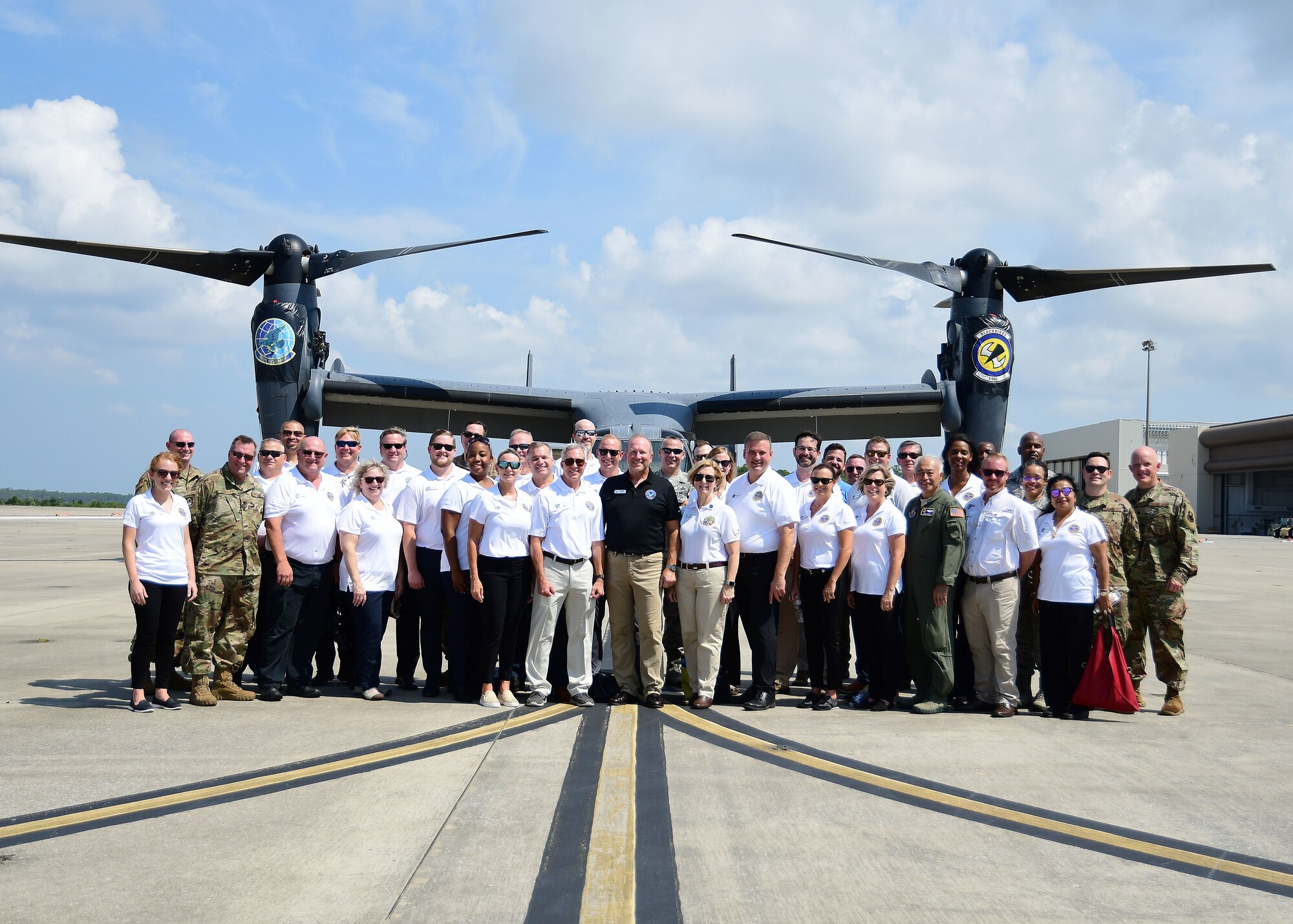 Civic leaders from metro Atlanta pose with tour coordinators in front of a CV-22 Osprey at Hurlburt Field, Florida, Aug. 14, 2019.