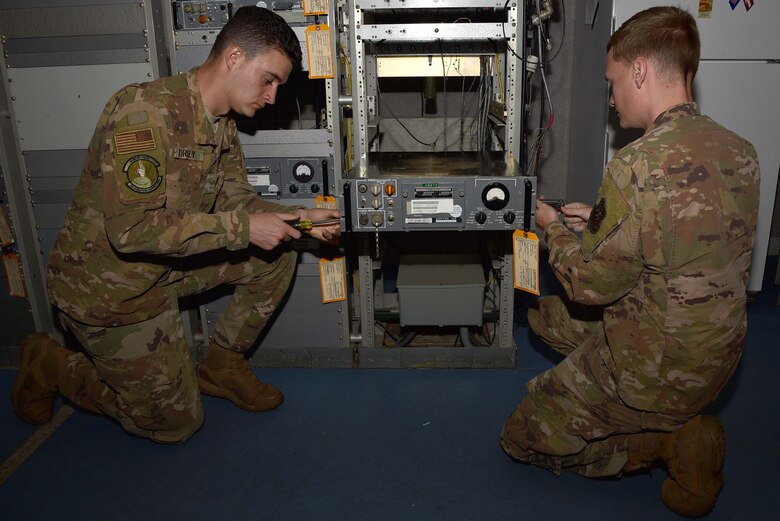 Airman 1st Class Adam Worley and Cory Leatherman, 22nd Operations Support Squadron Radar, Airfield and Weather Systems technicians, replace a radio to run a diagnostics check Aug. 13, 2019, at McConnell Air Force Base, Kan. RAWS is a vital component in maintaining and servicing all communication equipment used for safe aerial operations. (U.S. Air Force photo by Airman 1st Class Marc A. Garcia)