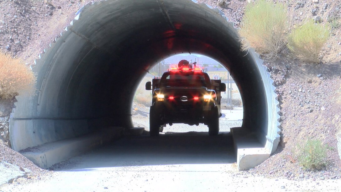 The new, smaller, quick response fire engine fits neatly through the access tunnel leading from Marine Corps Logistics Base Barstow, California, to the Marine Memorial Golf Course, August 9. Without the smaller Types-6 fire engine, emergency crews would have to travel a few miles and minutes out of their way to bypass the tunnel.