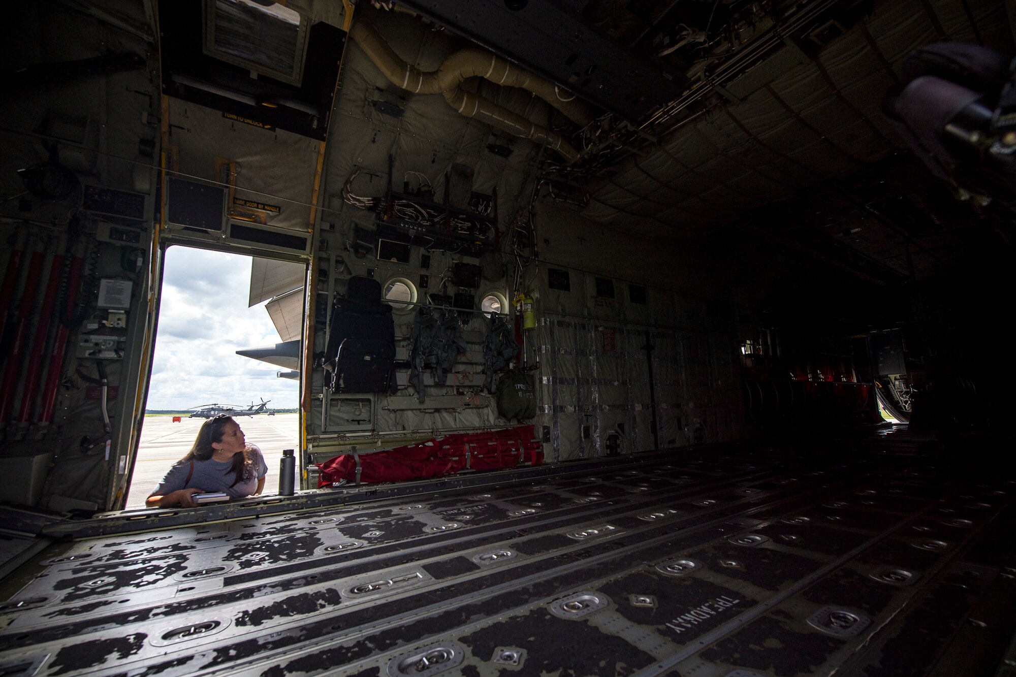 A Team Moody spouse looks inside of an HC-130J Combat King II aircraft during a Heart Link spouse orientation Aug. 21, 2019, at Moody Air Force Base, Ga. The orientation is geared toward providing all spouses and family members with the necessary support and information to ensure that they are aware of the resources available to them such as: Tricare, legal assistance, Airman and Family Readiness Center and financial assistance. During the orientation, spouses were given a static display tour to better familiarize them with the aircraft and mission here. (U.S. Air Force photo by Airman 1st Class Eugene Oliver)