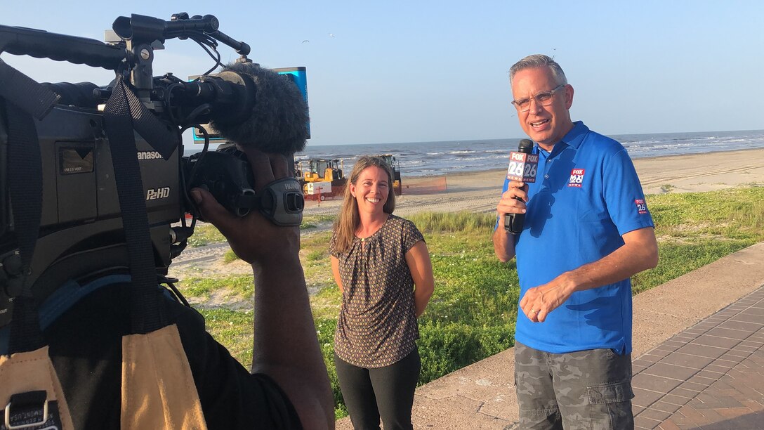 GALVESTON, Texas (August 20, 2019) Tricia Campbell, U.S. Army Corps of Engineers Galveston District operations manager, discusses the beach nourishment project currently taking place west of 61st street with Fox 26 reporter Ruben Dominguez. The project is in conjunction with the broader project to dredge the Houston and Galveston channels. The nourishment project, a collaboration between USACE, the Texas Land Office and the Galveston Park Board of Trustees, is expected to place up to 711,000 cubic yards of material along the existing beach.