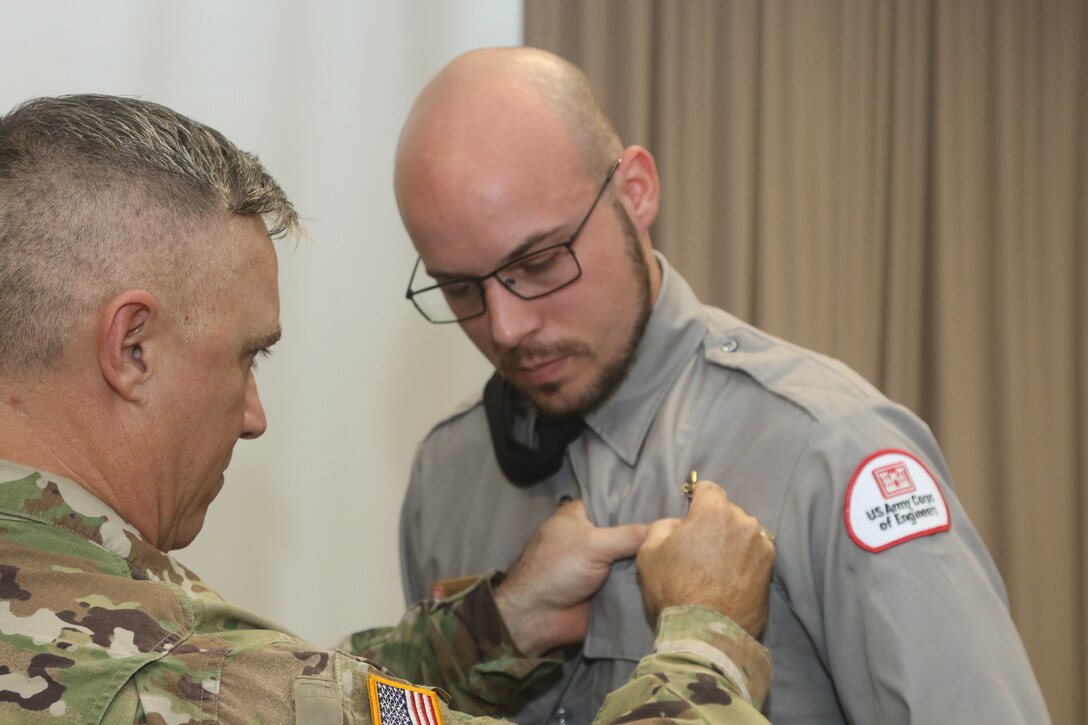 GALVESTON, Texas (Aug. 13, 2019) -As is tradition, the District Commander, Col. Timothy Vail, pins the U.S. Army Corps of Engineer Badge on Ranger Foote’s uniform signifying the trust and confidence placed in Ranger Foote to exercise his citation authority judiciously and protect the interests of both the U.S. Army Corps of Engineers and the United States Government by safeguarding the environmental, cultural, and natural resources of Federal lands. Therefore, Ranger Foote is assigned Galveston District Badge 1797 in order to execute his newfound duties (U.S. Army Corps of Engineers photos by Francisco Hamm).